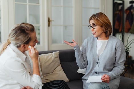 Behavior analyst discussing treatment plan with client in a counseling session